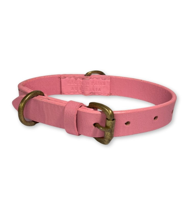 A Bald Collar Pink by Georgie Paws with a brass hardware buckle and d-ring, showcasing an embossed brand name, against a white background.