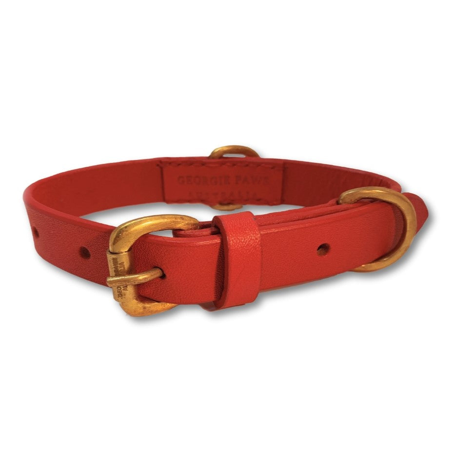 A handmade red buffalo leather dog collar with a golden buckle and d-ring, featuring an embossed brand name "Georgie Paws.