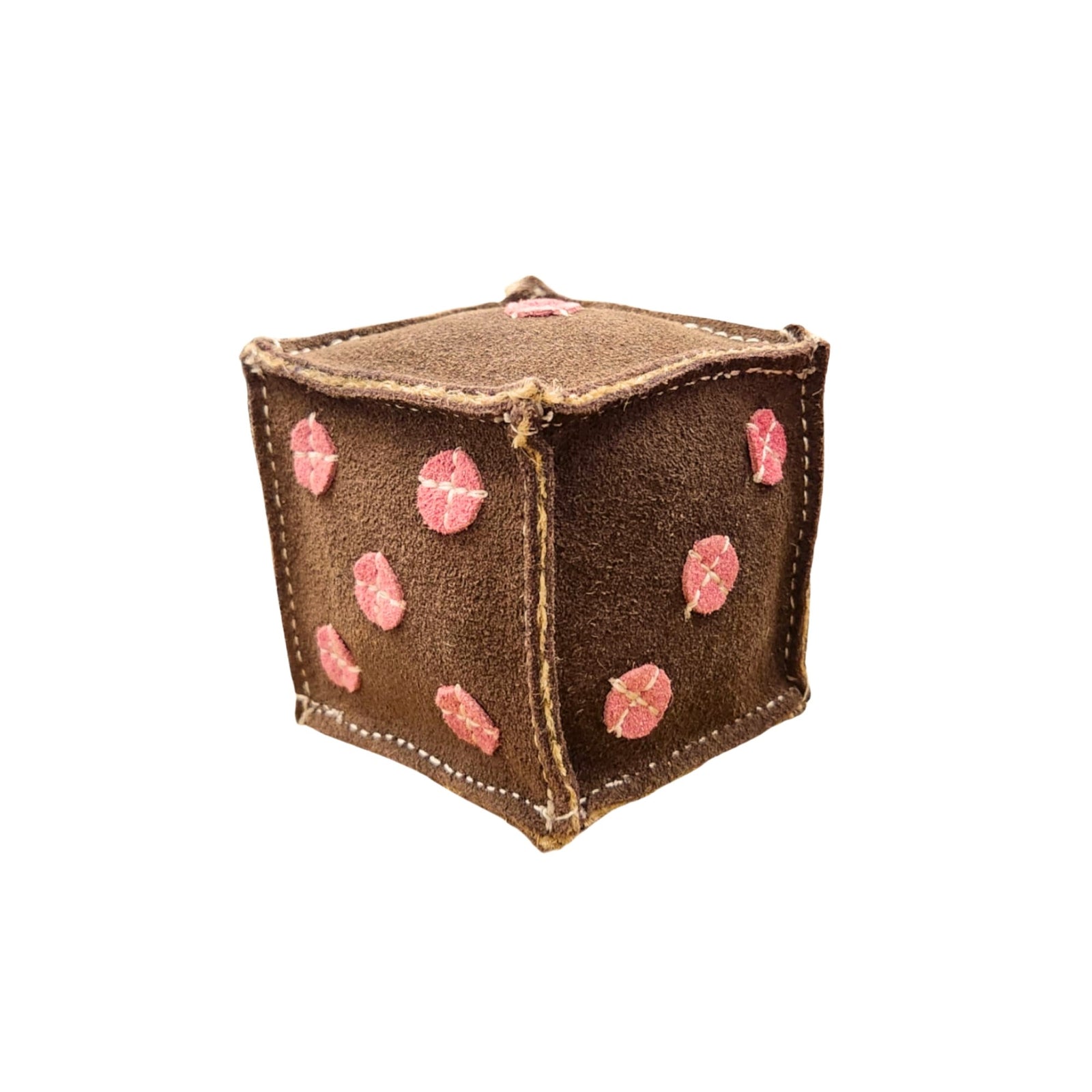 The Dice -chicory from Georgie Paws is a soft, textured die with a suede-like brown surface adorned with pink embroidered dots, ideal for adding vibrant colors to your family game night. Visible stitching along its edges enhances its handcrafted appearance. Each face of the die showcases a different number of pink dots, representing traditional dice values.