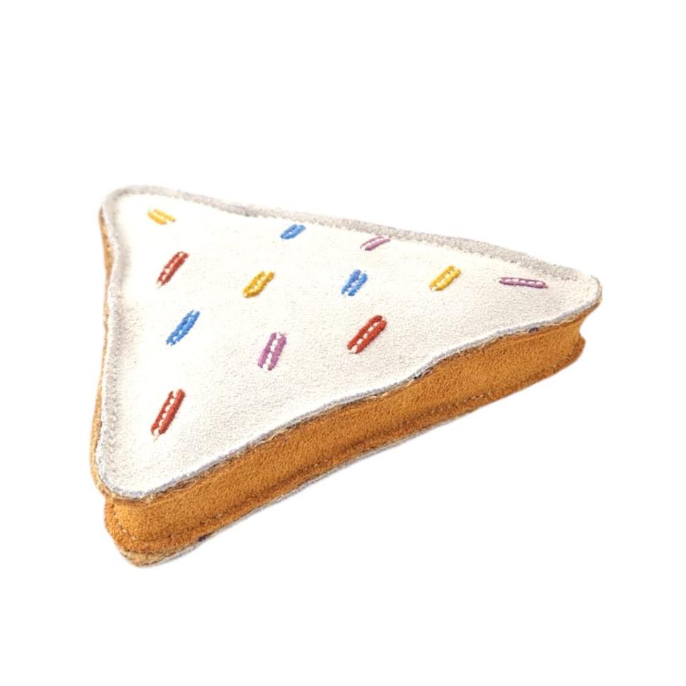 Introducing the Georgie Paws Fairy Bread Toy: a triangular plush resembling a sandwich slice, with white frosting and colorful stitched sprinkles in red, orange, blue, and purple. Crafted from pet-safe materials, its brown fabric sides mimic bread crust for a whimsical charm.