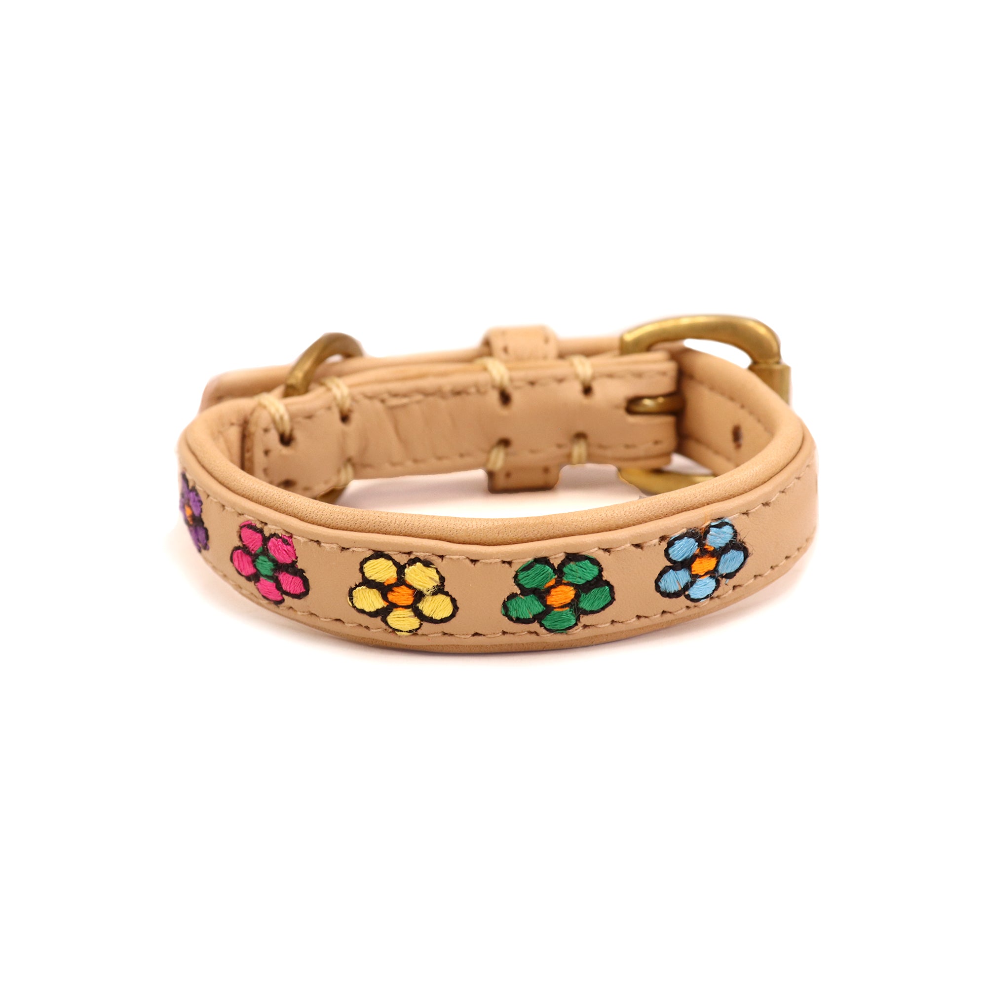 A Botanic Fleur collar from Georgie Paws, adorned with stitched daisies in blue, green, yellow and red. It features a gold buckle and loop, with visible stitching along the edges, set against a white background.