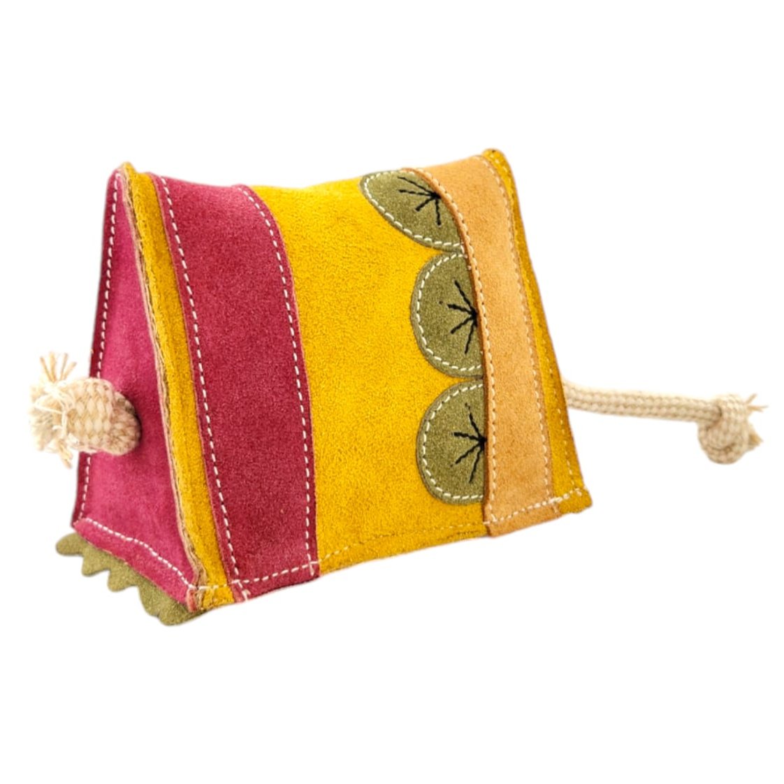 The Kiwi Sponge Cake by Georgie Paws is a vibrant, triangular doorstop with pink, yellow, and tan stripes, decorated with green leaf motifs and white stitching. Each end features a knotted cotton rope for added rustic charm.