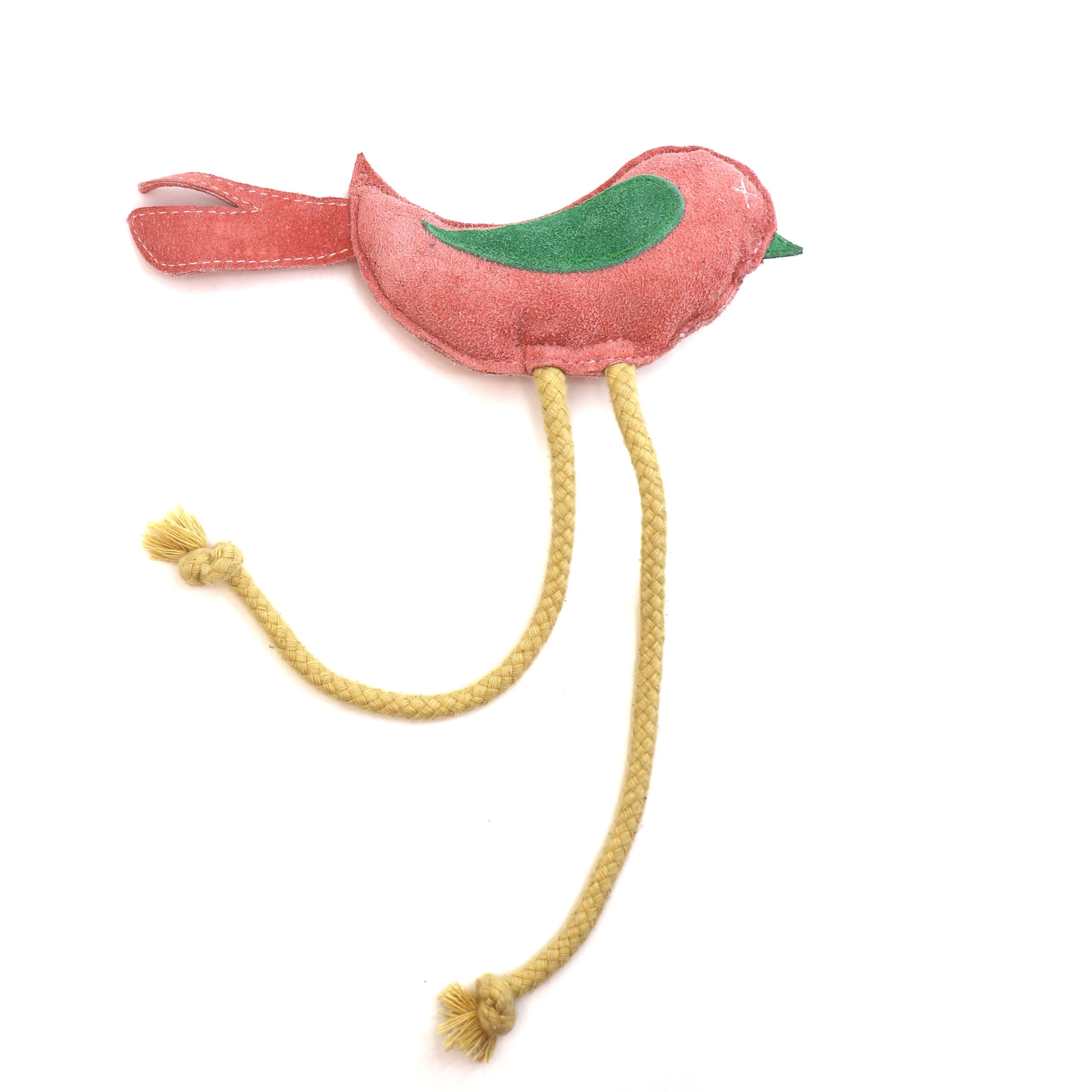 A Birdy Toy in pink fabric bird-shaped toy with a green wing and long yellow rope legs with tassel ends, designed as a biodegradable toy by Georgie Paws, isolated on a white background.