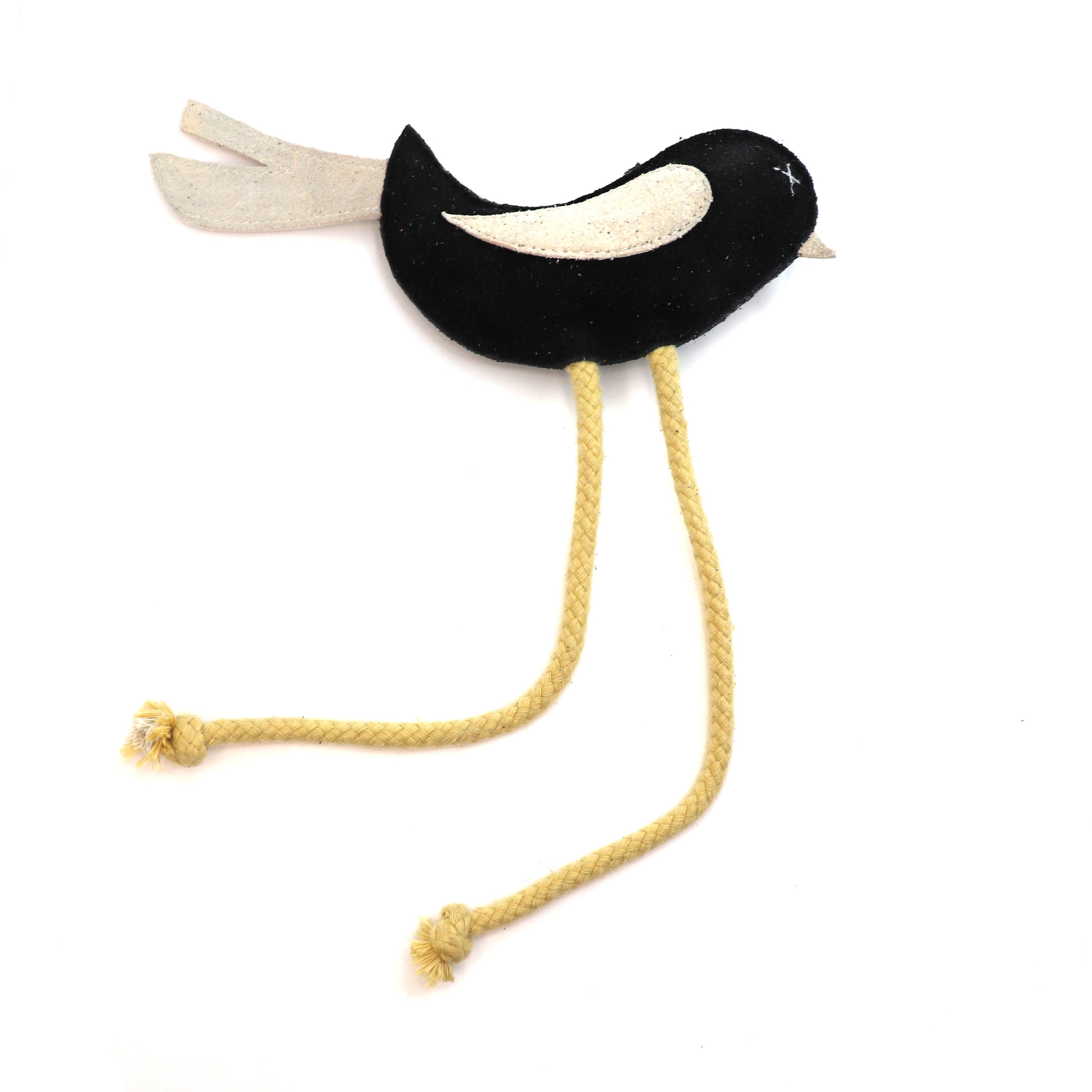 A whimsical Birdy Toy - black + chalk by Georgie Paws with long, yellow rope legs finished with knotted ends, isolated on a white background.