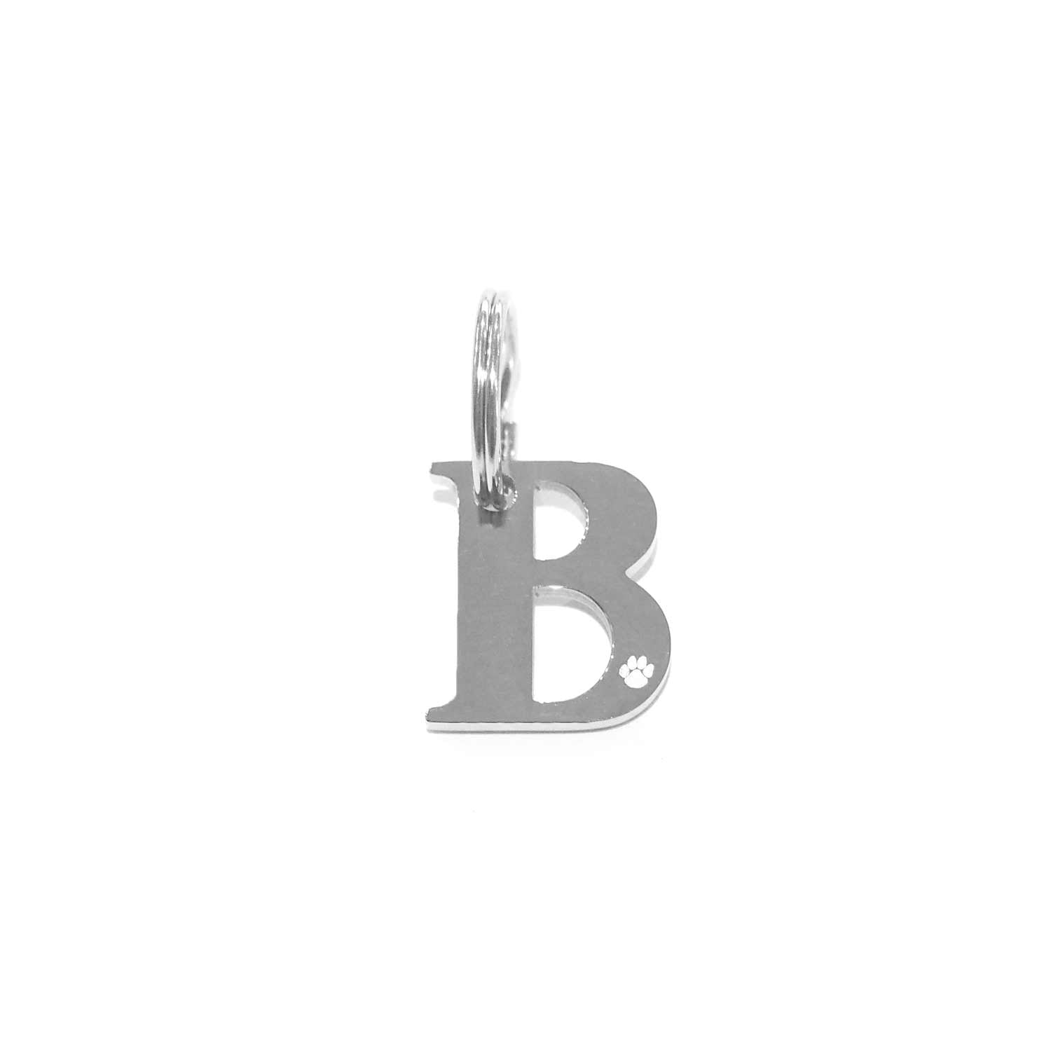 Georgie Paws Initials - Collar Charms: A silver stainless steel "B" charm with a small loop for attaching to pet collars, featuring a tiny paw print cutout at the lower right corner on a white background.