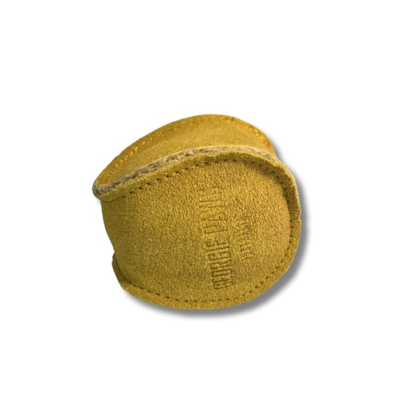 A worn, golden leather Georgie Paws baseball with visible stitching and fading text, isolated on a white background, indicating use and age. This eco-friendly item highlights sustainability in sports equipment.