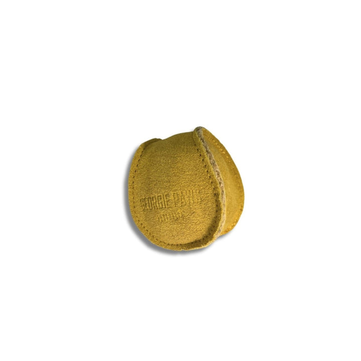 The Georgie Paws Ball - Gold is a small, round dog ball made from yellowish-brown coconut fibre with visible stitching and embossed text. Its handmade look features a slightly uneven surface and it sits on a plain white background with a faint shadow below.