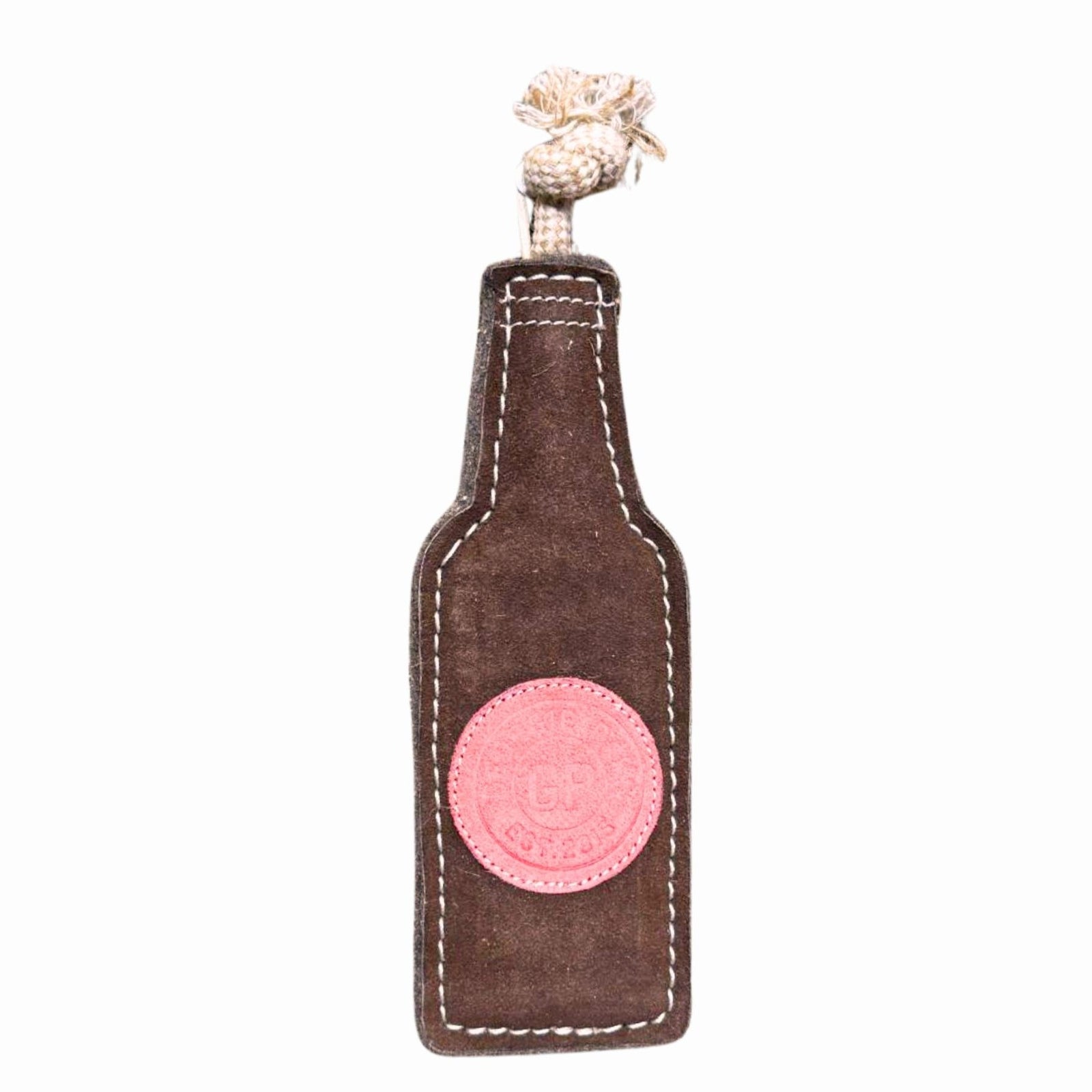 The Georgie Paws Bevvy Dog Toy is a durable, beer bottle-shaped toy made of brown fabric with white stitching, a pink patch, and a knotted beige rope handle. Shown on a white background.
