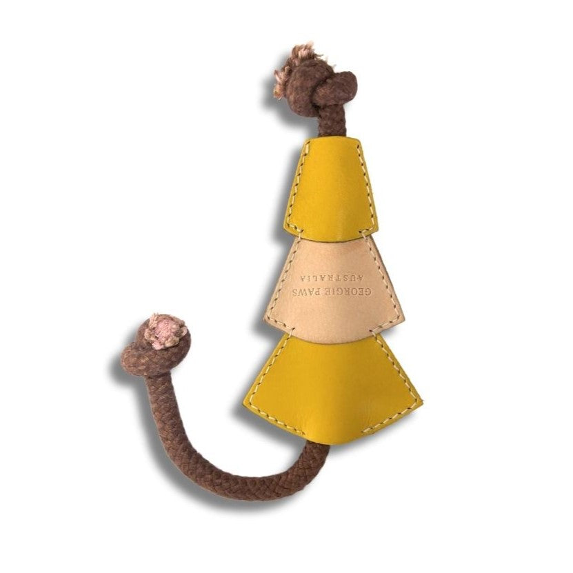 A cat toy resembling a Georgie Paws Bush Christmas Chew Toy made of Veg-Tanned Buffalo Leather, with a playful design featuring stitched details and a braided trunk, informing engaging interactive playtime for pets.