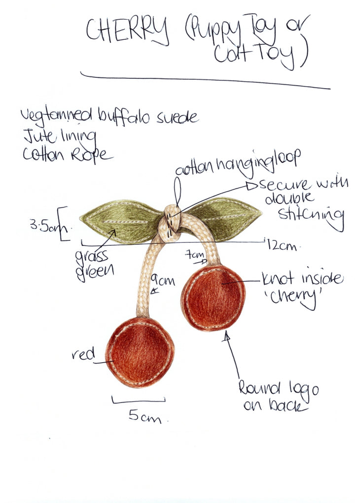 Hand-drawn diagram of the Georgie Paws Cherry Pup Toy (also for Cats): two red suede cherry circles hang from a cotton rope with green leaves, double stitching, labeled measurements, and a round logo on the back.