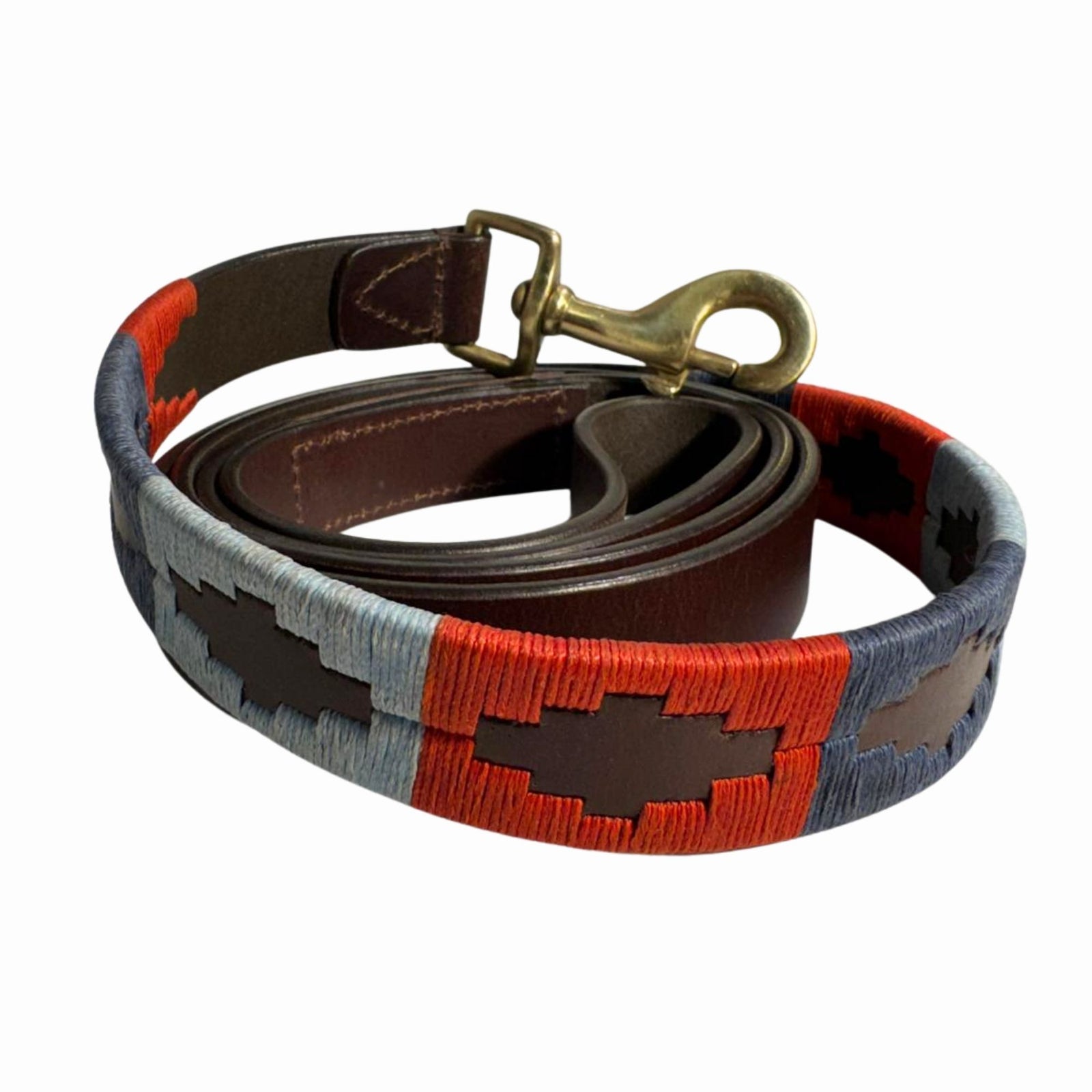 The POLO LEAD - Claude by Georgie Paws is a rolled-up, durable Buffalo leather dog leash with a brass clasp. Featuring red, blue, and brown hand-stitched geometric patterns, it adds colorful accents to thick brown leather.