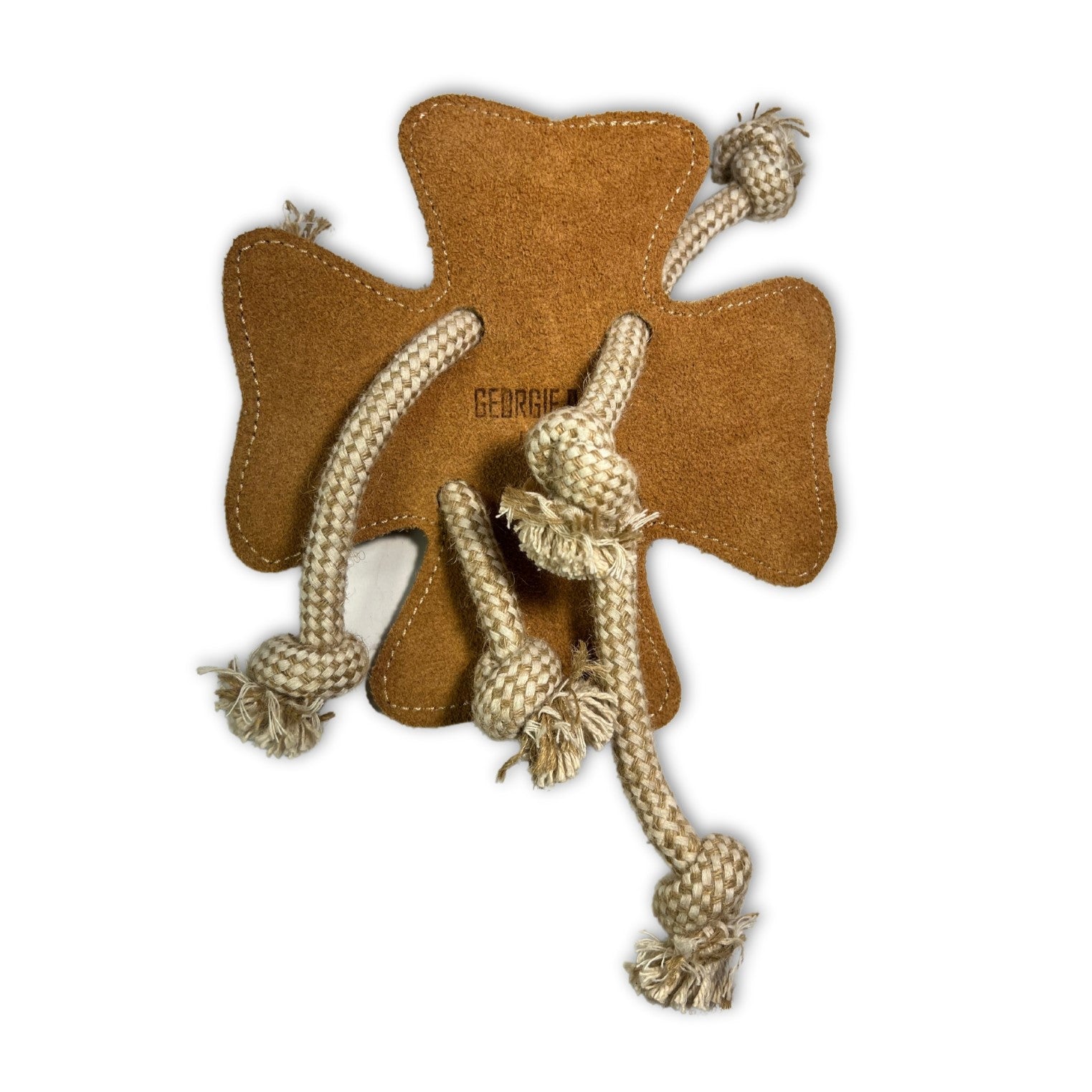 A brown, star-shaped dog toy made of Buffalo Suede with the name "Clover - Natural" embroidered in the center. It has four knotted rope legs extending from the sides, each ending in Georgie Paws.