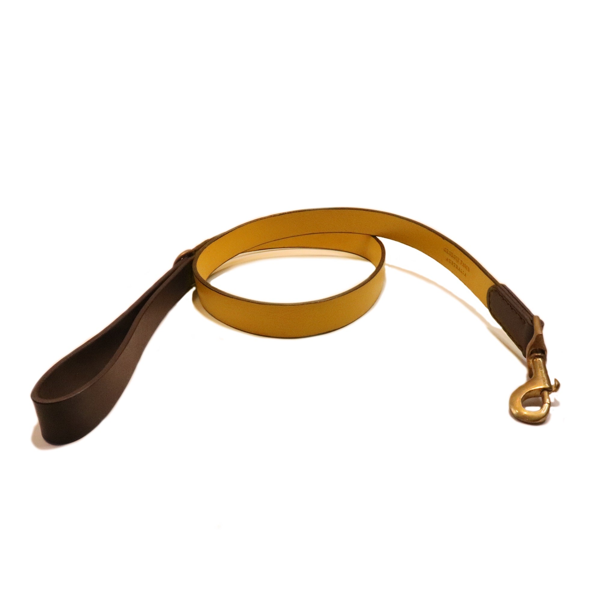 A sustainably made Cooper Lead - wheat with a golden-yellow finish and a contrasting brown handle, featuring a metal clasp, coiled neatly on an isolated white background by Georgie Paws.