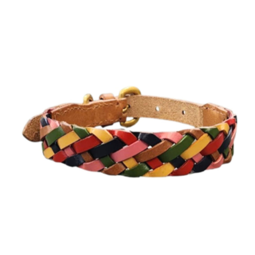 The Credence Collar by Georgie Paws is a braided buffalo leather dog collar in pink, yellow, red, green, and black strips with a gold buckle and adjustable holes for comfort, shown on a white background.
