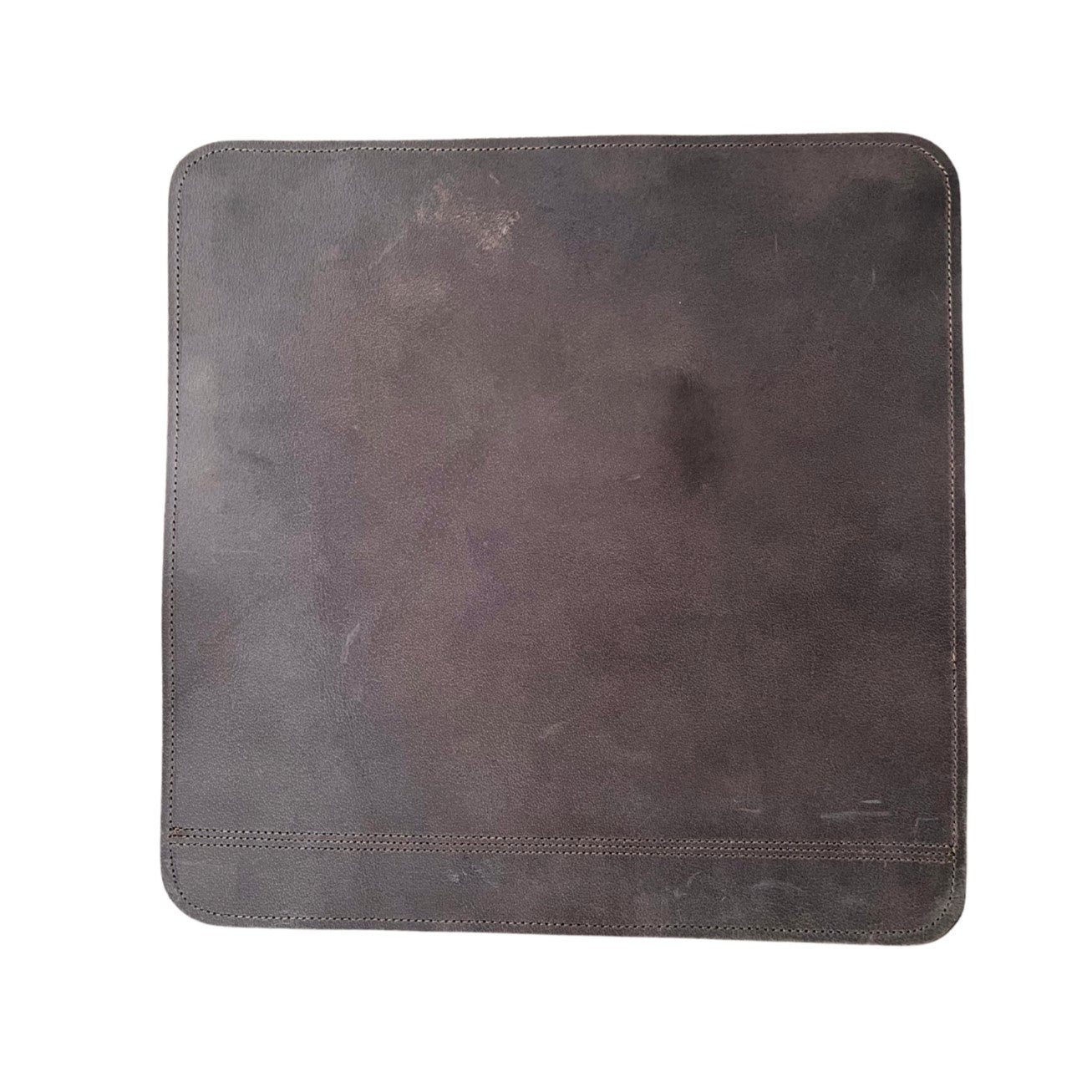 A worn-out dark gray buffalo leather dinner mat with visible scratches and scuff marks. It features a simple square design, measuring 38cm x 38cm, with stitched edges, isolated on a. Brand Name: Georgie Paws