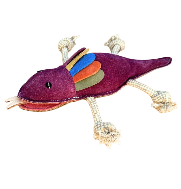 Introducing the Georgie Paws "Fink the Frillneck Lizard" Dog Toy—a handmade plush toy featuring a purple body, multicolored felt frills in blue, green, and orange, white stitched eyes, a playful felt tongue sticking out, and sturdy rope limbs. The toy is pictured laying flat on a white background.