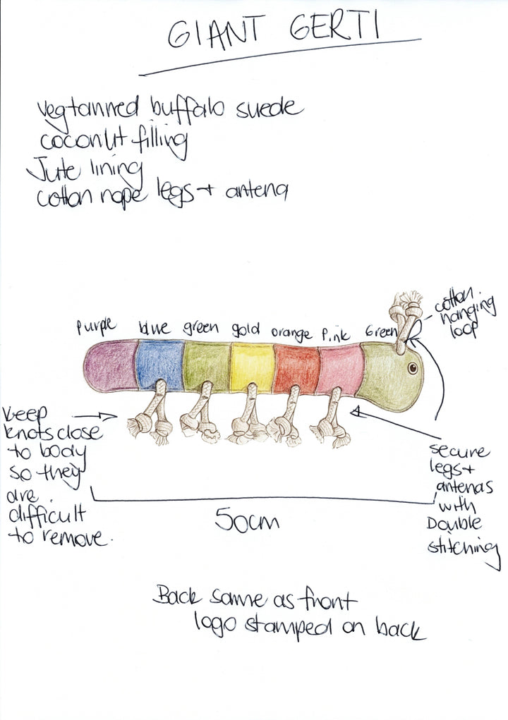 Giant Rainbow Gerti for Giant Dogs by Georgie Paws is a hand-drawn plush caterpillar dog toy featuring colorful body segments, cotton rope legs and antennae, jute-cotton hanging loop, and strong stitching—eco-friendly and compostable.
