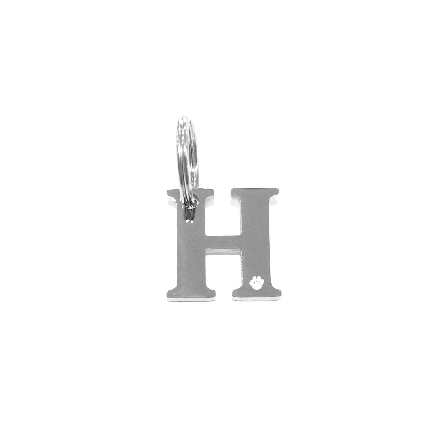 The Georgie Paws Initials - Collar Charms features a stainless steel "H" charm with a circular attachment ring, engraved with a small paw print—ideal as a dog gift. The background is plain white.