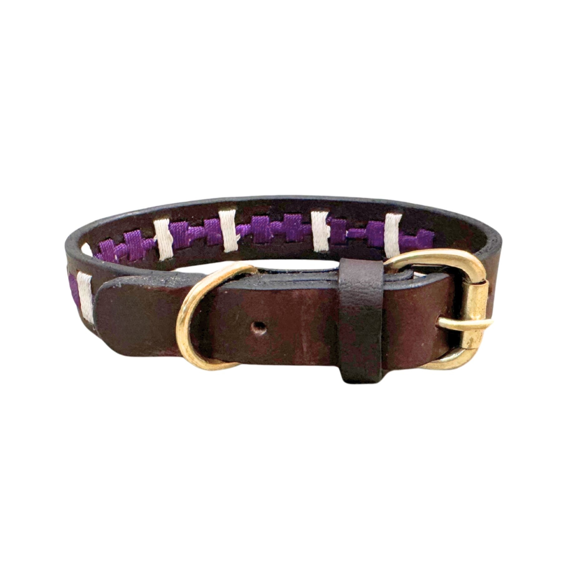 The Polo Collar - Lokki purple by Georgie Paws combines style and craftsmanship, featuring dark brown buffalo leather adorned with white and purple woven detailing. It is equipped with a shiny brass buckle and D-ring, while the interior boasts a purple fabric lining that beautifully contrasts the rugged leather.