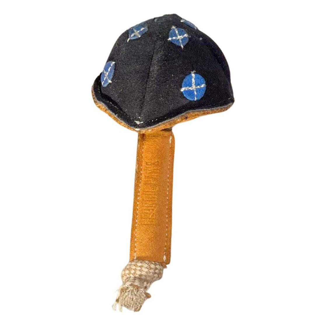 Maisy the Mushroom Dog Toy - Blue by Georgie Paws is a handmade plush toy featuring a dark cap decorated with blue and white circular patterns. The tan fabric stem has visible stitching and ends with a short rope knot at the bottom, all set against an uncluttered white background.