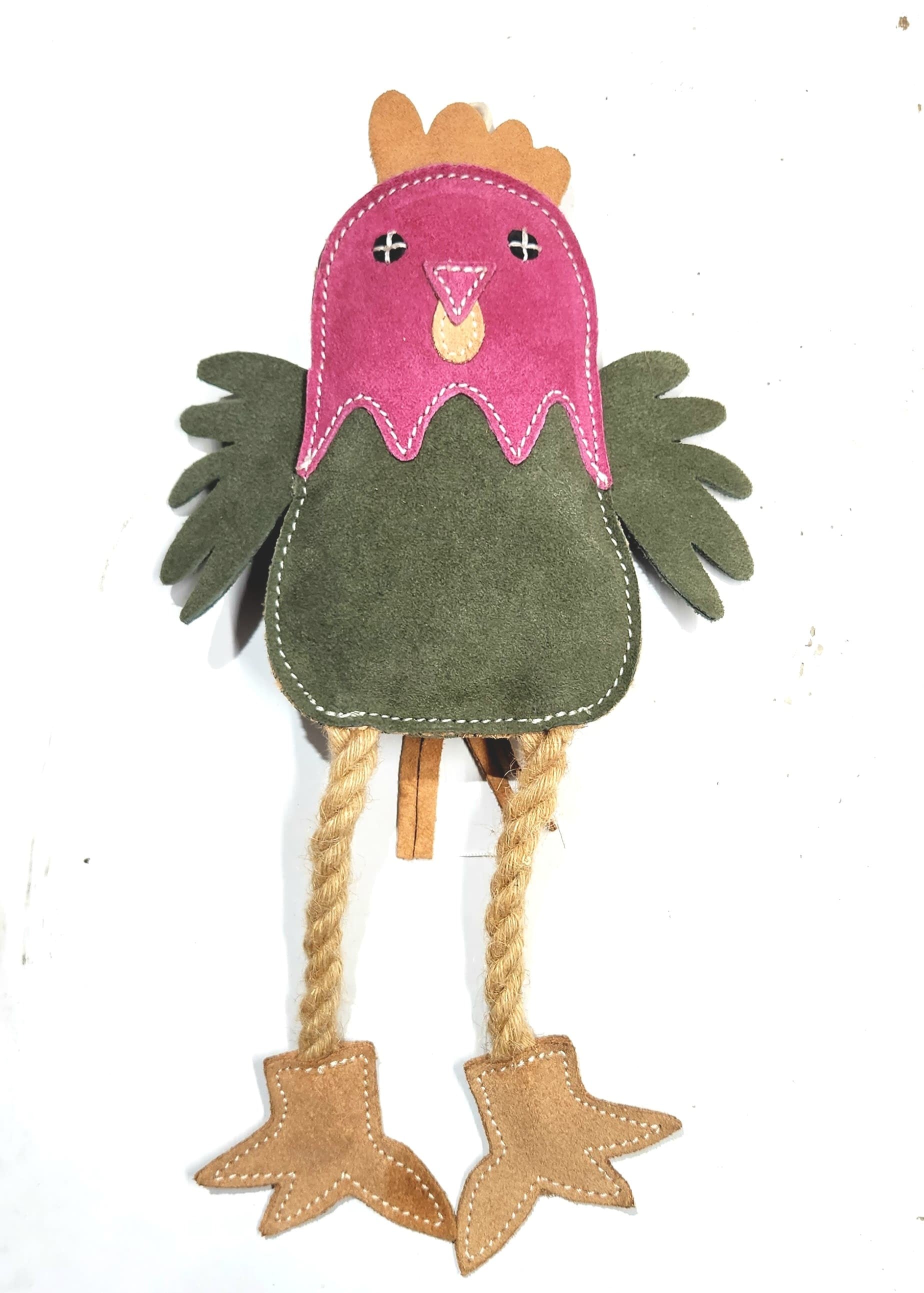 A colorful felt craft resembling Matilda the Chicken, featuring a pink head with eyes and a beak, a green body, brown buffalo suede wings and feet, and braided twine as legs, set against.