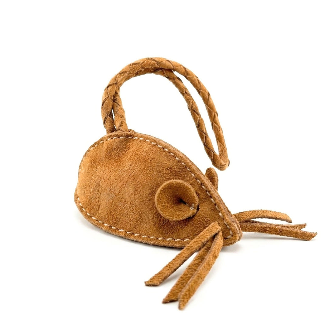 The Georgie Paws Mouse Poobag Dispenser in Sand is a small, brown suede dog accessory with stitched edges, braided tail, and string whiskers, shaped like a mouse and shown on a white background.