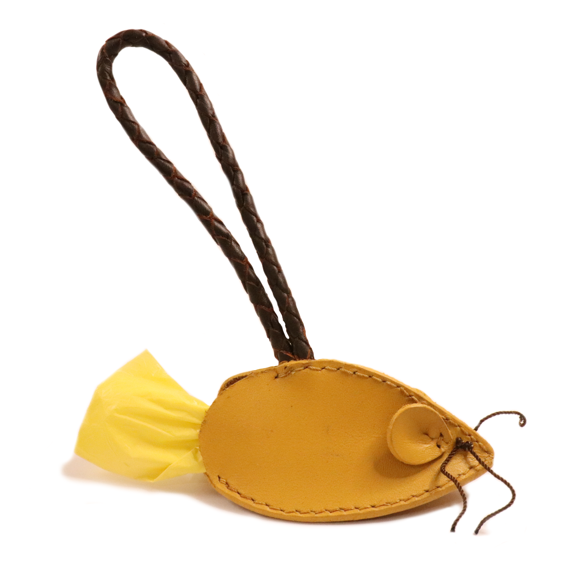 A handmade buffalo leather Mouse Poobag Dispenser wheat with a long twisted handle, resembling a mouse with protruding ears and tail, complemented by a bright yellow fabric detail, isolated on a white background from Georgie Paws.