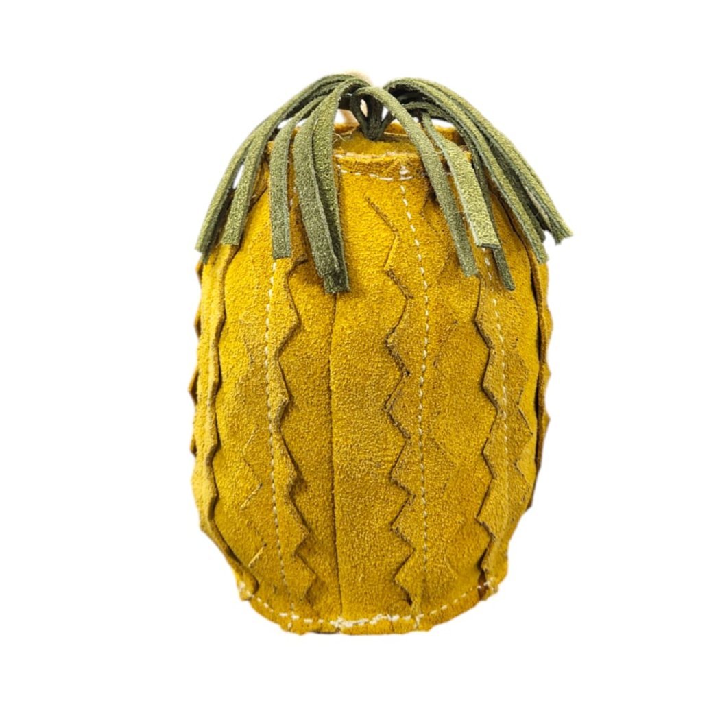 The Penny Pineapple Dog Toy by Georgie Paws is a plush, yellow dog toy shaped like a pineapple, featuring a textured zigzag pattern and green suede leaves on top. Crafted from sustainable materials, it is shown isolated on a white background.