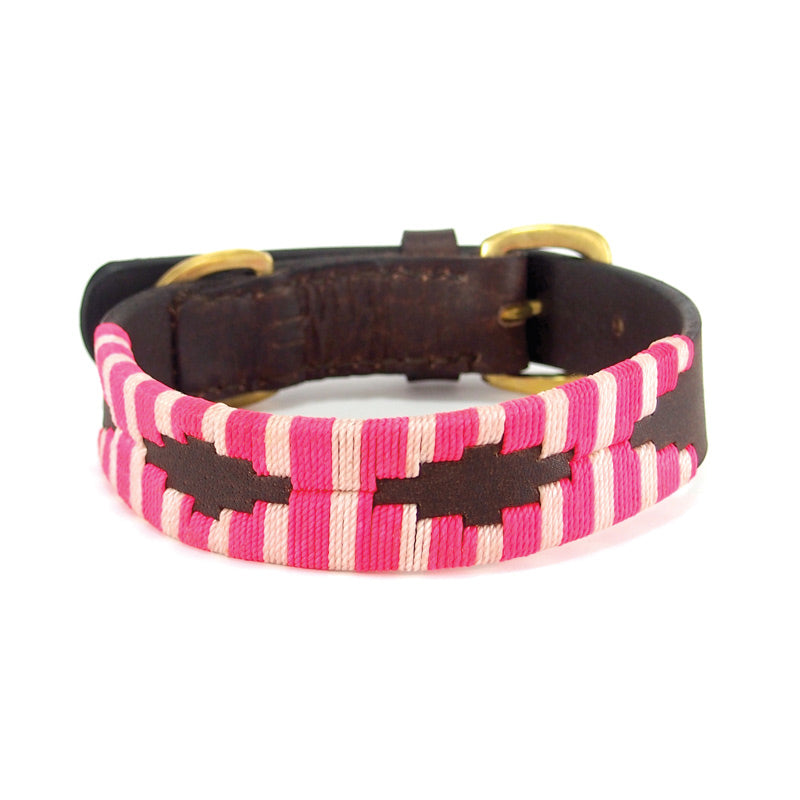 A handmade, Georgie Paws Polo Collar - Pinky with a Buffalo leather inner lining and brass hardware, isolated on a white background.