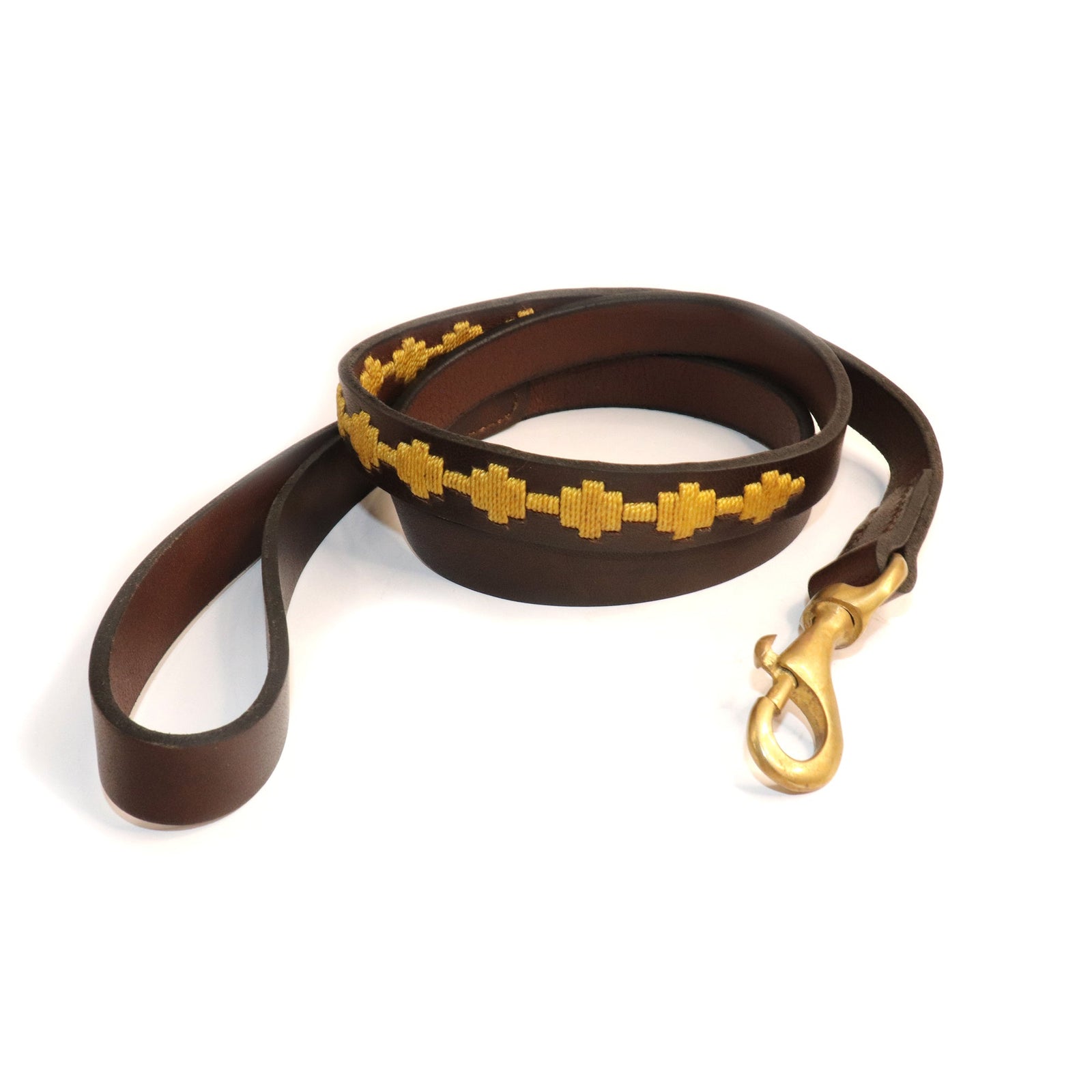 The Polo Bark Lead - Wheat by Georgie Paws is a brown vegetable tanned buffalo leather dog leash featuring a handle loop, yellow stitched geometric pattern, and a brass swivel clasp. This handmade leash is shown coiled on a white background.