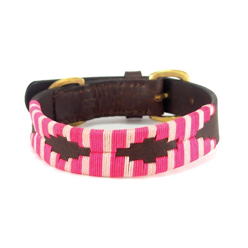 Introducing the Polo Collar - Pinky by Georgie Paws: this brown leather dog collar is adorned with brass hardware and features a stitched pattern of pink, magenta, and white geometric stripes wrapping around the center. Carefully handmade from natural materials, it boasts a vibrant and stylish look—perfect for adding a unique touch to your pup’s accessories.