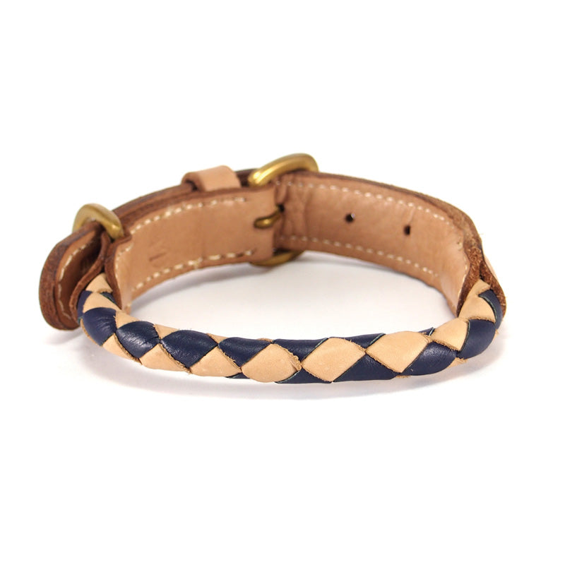 A braided buffalo leather dog collar with blue and tan accents and a gold-tone buckle, against a white background, showcasing the Georgie Paws Rocket Collar navy + natural for busy dogs.