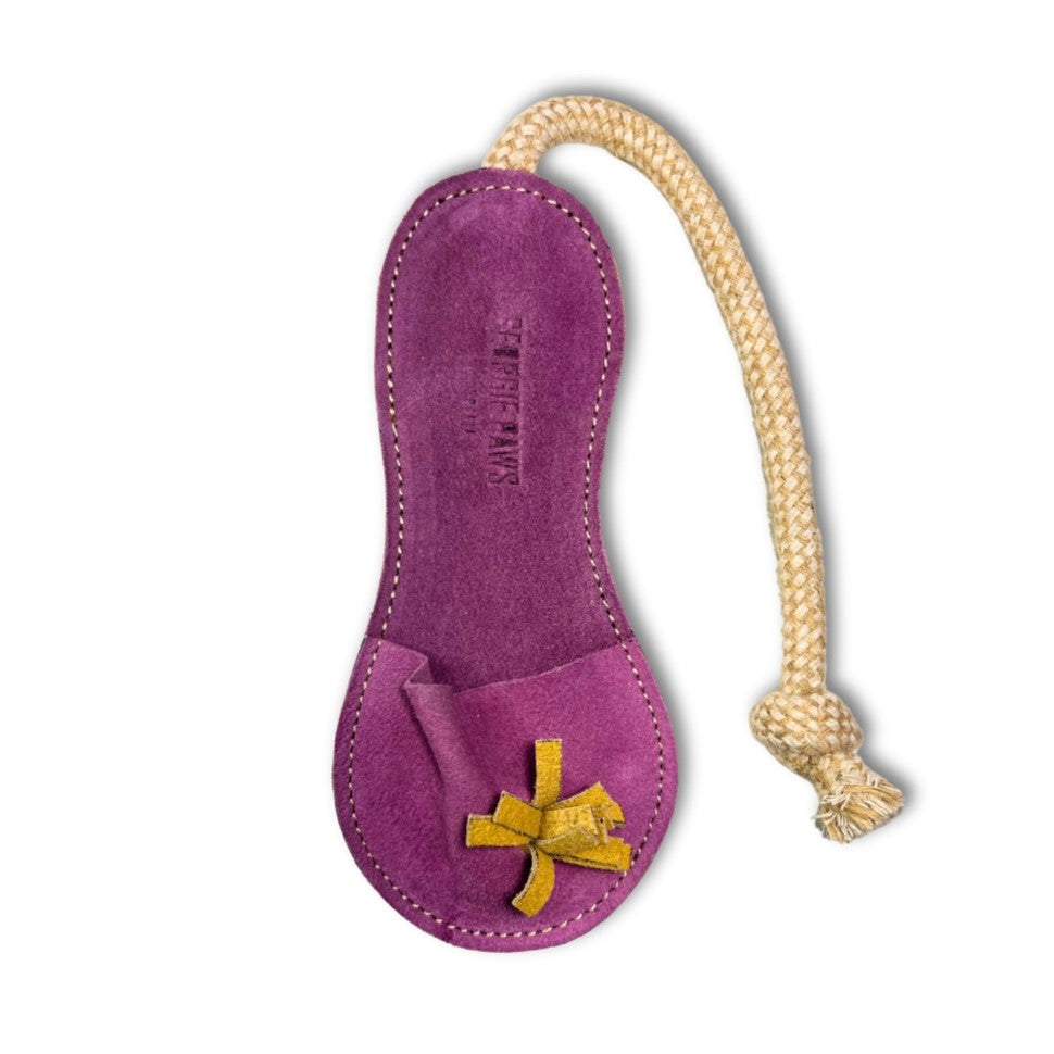 A luxurious purple Georgie Paws Sigrid Slipper made from sustainable Buffalo Leather, featuring an elongated silhouette and a sturdy, braided cotton rope for hanging, isolated on a white background.