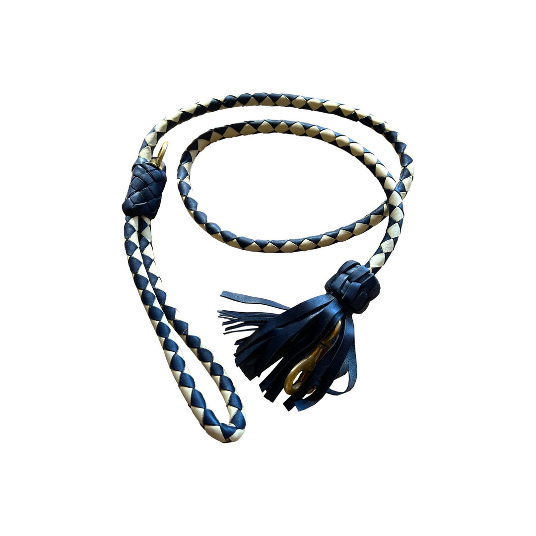 The Swanky Lead - Navy by Georgie Paws, handmade from vegetable tanned buffalo leather, features a navy and beige braided design. It is coiled on a white background, showcasing its looped handle at one end and a decorative knot with leather tassels at the other.