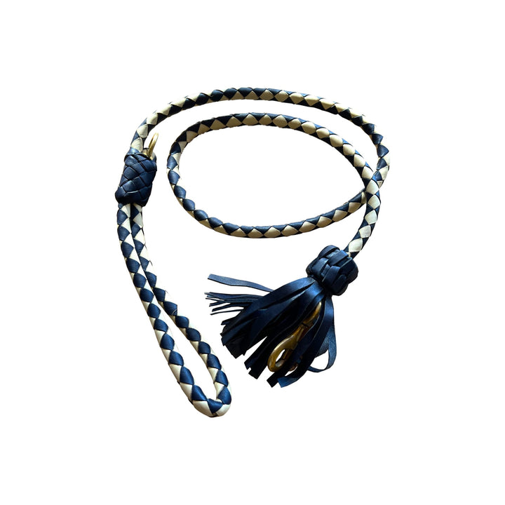 The Swanky Lead - Navy by Georgie Paws, handmade from vegetable tanned buffalo leather, features a navy and beige braided design. It is coiled on a white background, showcasing its looped handle at one end and a decorative knot with leather tassels at the other.