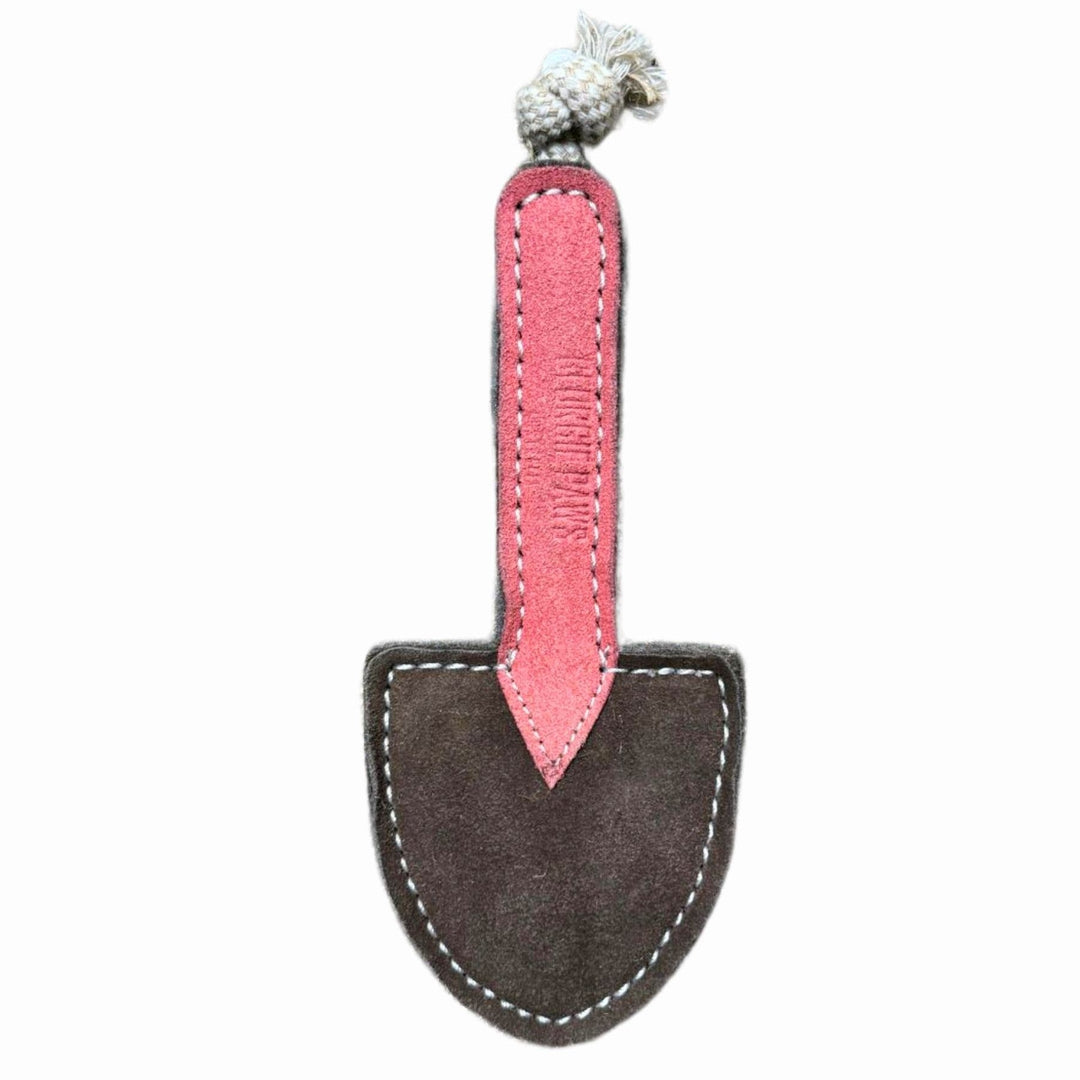 Introducing the Trusty Trowel - Dog Toy by Georgie Paws: a small, eco-friendly dog toy crafted from suede-like fabric and designed in the shape of a garden trowel. It features a pink handle, brown spade, white stitching around the edges, and a white knotted rope at the top.