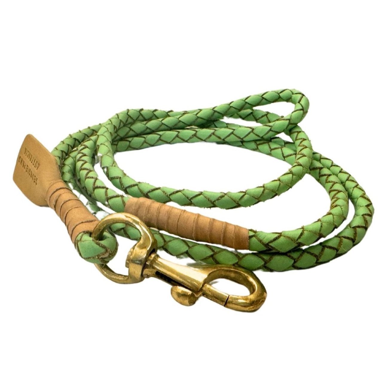 Introducing the Windsor Lead - Mint from Georgie Paws: This handmade coiled green braided rope dog leash features vegetable tanned buffalo leather accents, a brass swivel snap hook, and a leather tag embossed with text. With its intricate braiding and sturdy metal clasp, the Windsor Lead offers secure attachment in a stylish design.
