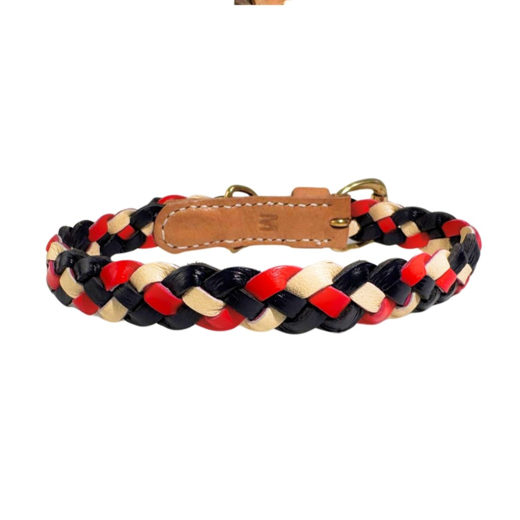 The Windsor Collar - Flag by Georgie Paws, designed for smaller dogs, features intertwining red, black, and beige leather strips with a tan buffalo leather buckle. It includes brass hardware like a D-ring for leash attachment and offers stylish flexibility in sizing.