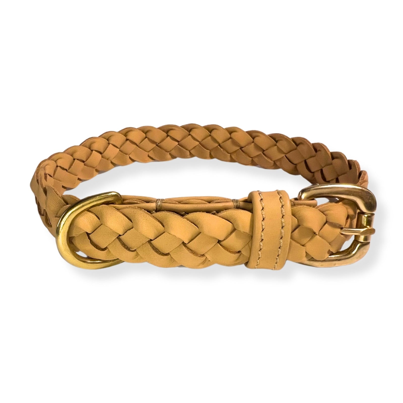 The Windsor Collar - Natural by Georgie Paws is a tan, braided buffalo leather dog collar for small dogs. It features a brass buckle and D-ring, an adjustable strap with a single loop for excess length, and showcases tight, intricate weaving against a white background.