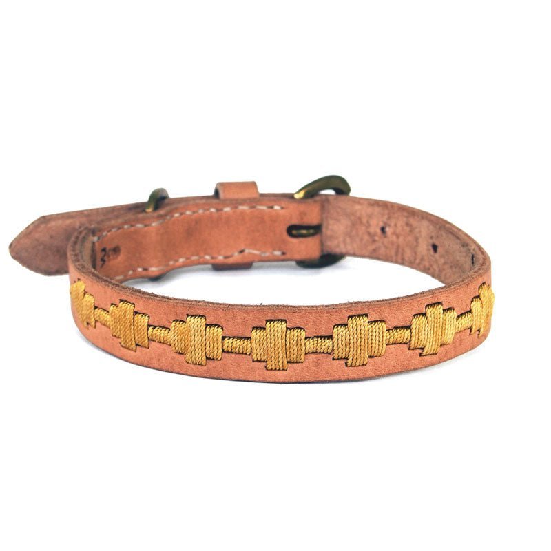 The Ethel Collar - Gold by Georgie Paws is a light brown, rustic collar handcrafted from natural vegetable tanned buffalo leather. It features yellow geometric stitched patterns, a metal buckle, a stitched border, and multiple adjustment holes for sizing, making it both decorative and functional.