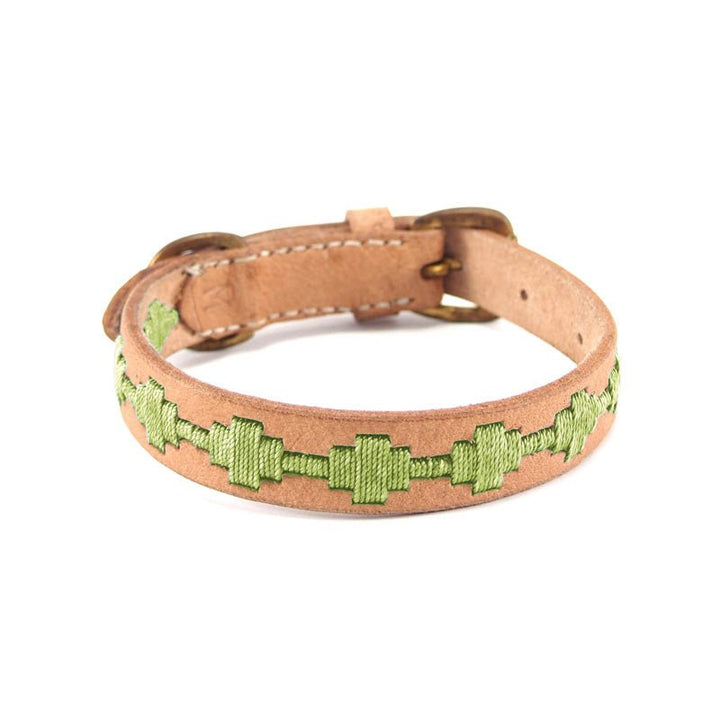 Introducing the Ethel Collar - Pear by Georgie Paws: a natural, handmade tan leather collar adorned with a green geometric embroidered pattern down the center and finished with metal buckle hardware. Displayed against a white background.