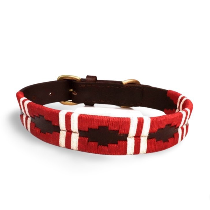 Introducing the Polo Collar - Kaliman by Georgie Paws: a handmade red and white woven dog collar adorned with geometric patterns and finished with a brown leather backing. This plastic-free accessory features gold metal hardware for fastening, offering your pup both style and sustainability.