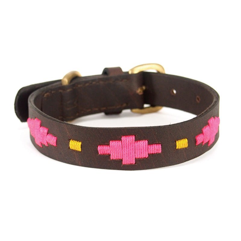 Introducing the Polo Collar - Megsie by Georgie Paws: a dark brown vegetable tanned buffalo leather dog collar with durable brass hardware. This stylish collar showcases embroidered geometric patterns in bright pink, complemented by small yellow accents running along its length. Designed for comfort and fit, it features multiple adjustment holes and a sturdy buckle.